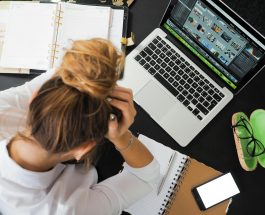 woman sitting in front of macbook