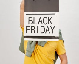 person holding a black shopping bag