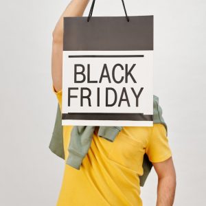 person holding a black shopping bag