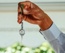 person holding silver key with clear gemstone
