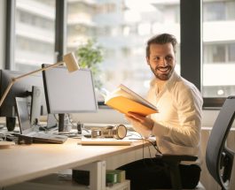 photo of man holding a book
