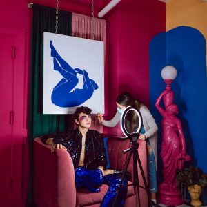 woman in black and white floral dress sitting on chair