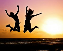 silhouette photography of jump shot of two persons