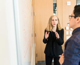 woman standing near whiteboard