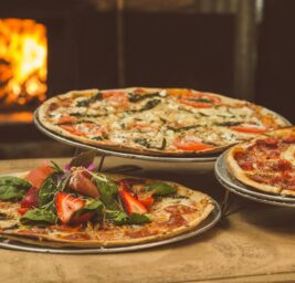 shallow focus photography of several pizzas