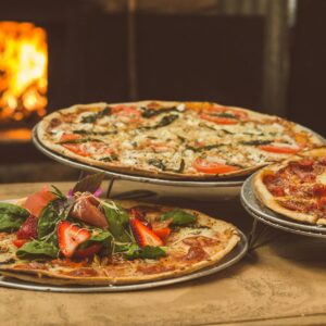 shallow focus photography of several pizzas