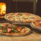 shallow focus photography of several pizzas