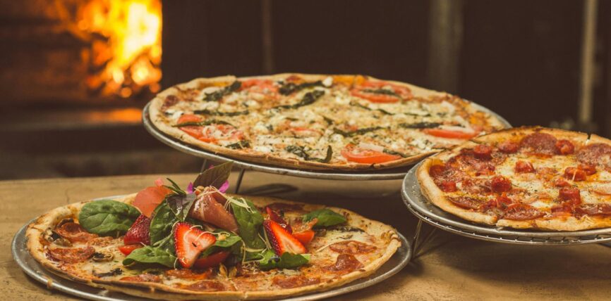 shallow focus photography of several pizzas