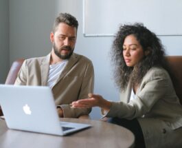 focused man working with female colleague in office