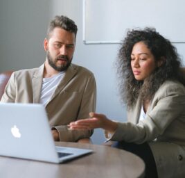 focused man working with female colleague in office