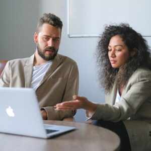 focused man working with female colleague in office