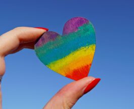 person holding multicolored heart decor