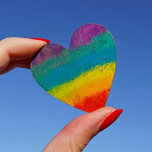 person holding multicolored heart decor