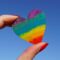 person holding multicolored heart decor