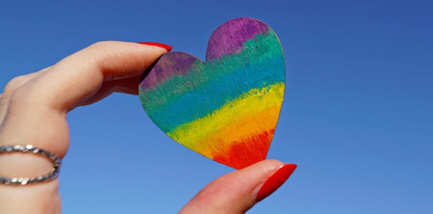 person holding multicolored heart decor
