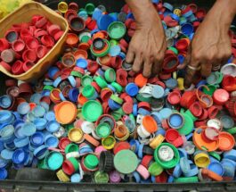 person hands on assorted color plastic lid lot