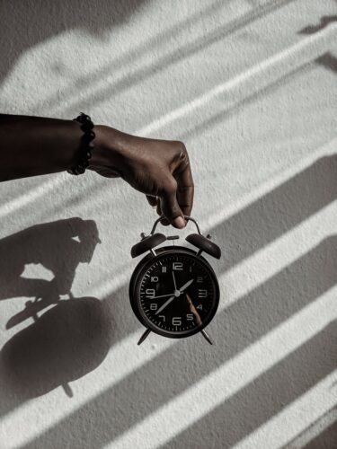 person holding a alarm clock