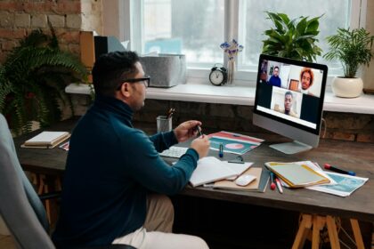 teacher video calling with his students using a computer