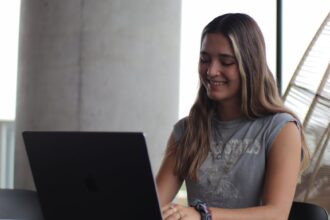 a woman sitting at a table with a laptop