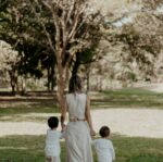 mother and children walking in a park