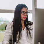 woman sitting by desk and working