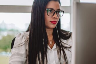 woman sitting by desk and working