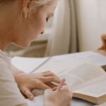 girl in white shirt reading book