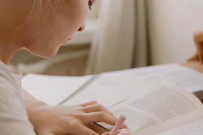 girl in white shirt reading book