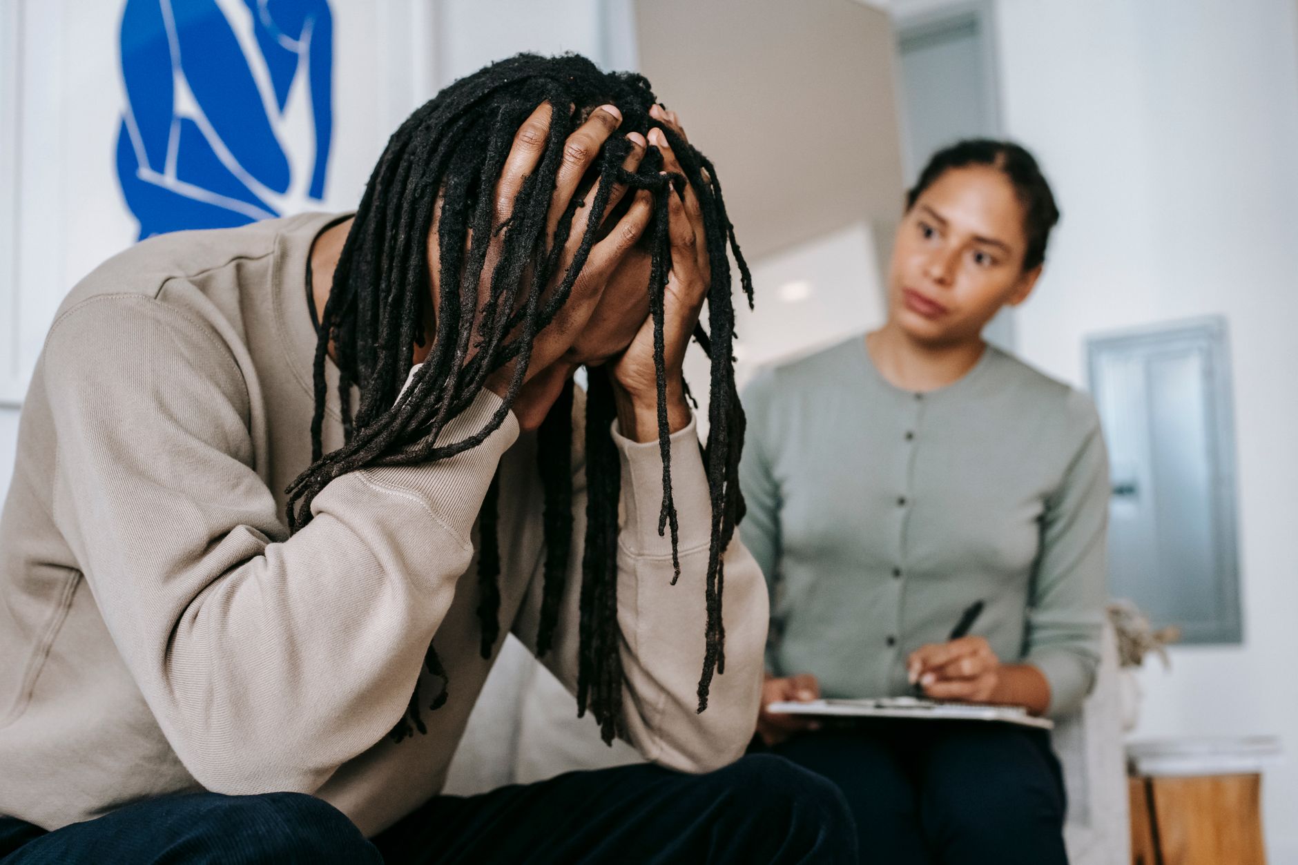unrecognizable desperate black man with attentive girlfriend at home