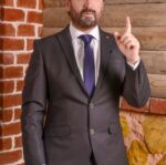 a man in a suit with a pointed finger