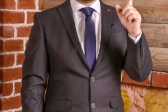 a man in a suit with a pointed finger