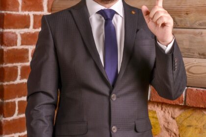 a man in a suit with a pointed finger