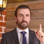 a man in a suit with a pointed finger
