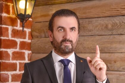 a man in a suit with a pointed finger