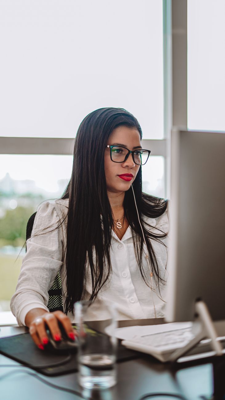 woman sitting by desk and working