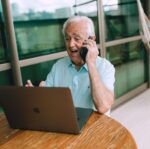 elderly man enjoying video call on laptop