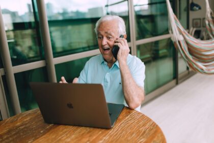 elderly man enjoying video call on laptop