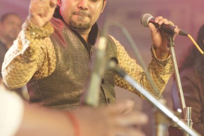 man in yellow printed long sleeves holding a microphone
