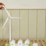 a scale model of houses and wind turbine on cardboard