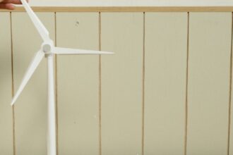 a scale model of houses and wind turbine on cardboard