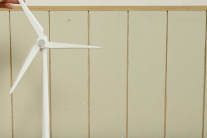 a scale model of houses and wind turbine on cardboard