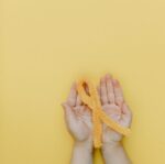 a person holding a yellow yarn