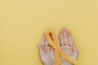 a person holding a yellow yarn