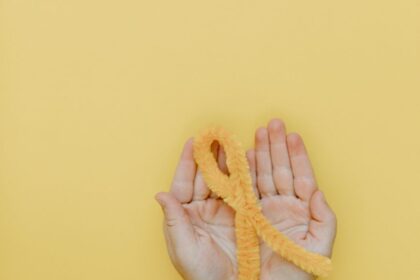 a person holding a yellow yarn