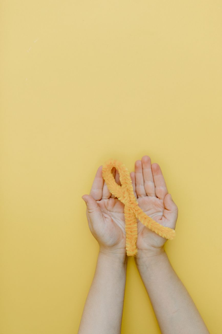 a person holding a yellow yarn