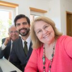happy mature couple posing with an office worker