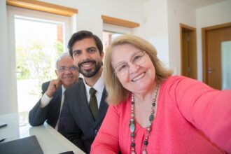 happy mature couple posing with an office worker