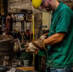 skilled welder working in industrial workshop