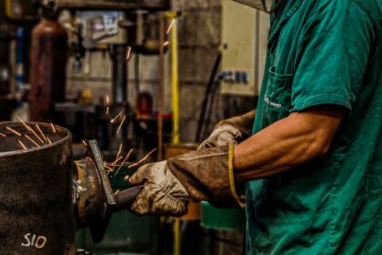 skilled welder working in industrial workshop